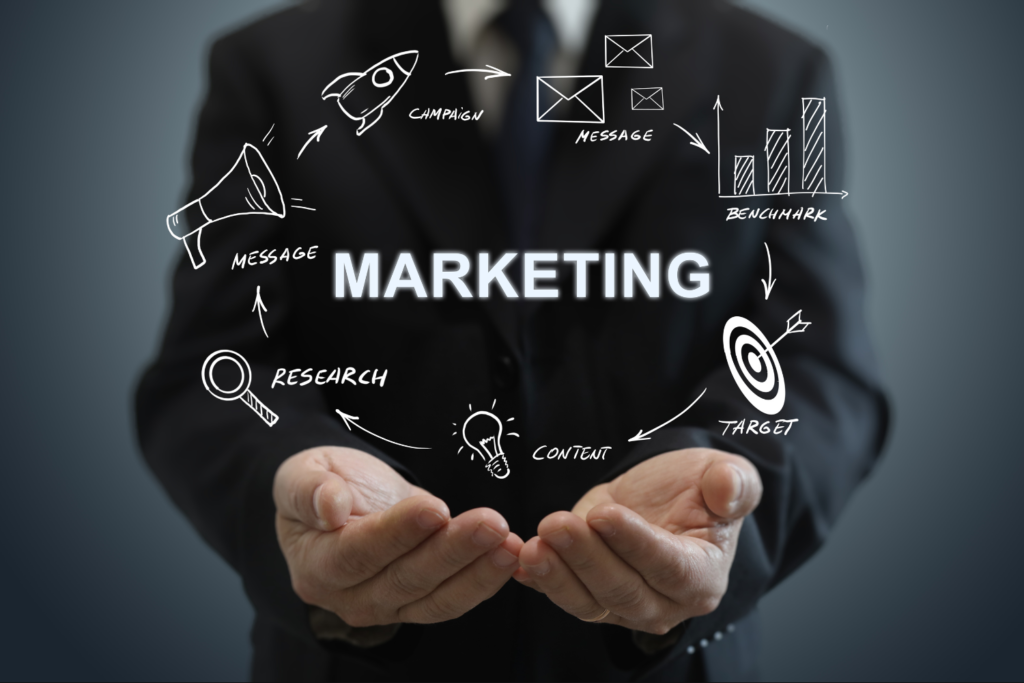 Geschäftsmann hält Marketing-Icons in den Händen, umgeben von Begriffen wie Campaign, Message, Benchmark, Target, Content und Research