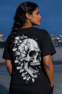 Schwarzes Skull Shirt an einer Frau von hinten auf einer Dachterrasse bei Nacht, großes weißes Horror Shirt Motiv mit Stadtlichtern im Hintergrund.